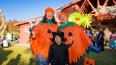 Picture of famiyl in costumes at halloween spooktacular event